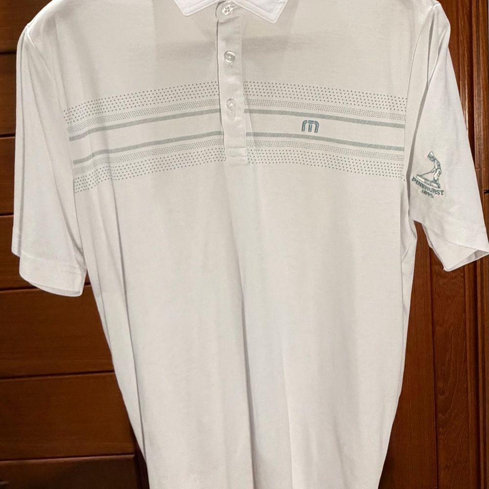 Travis Mathew White Short-Sleeve Polo with Subtle Stripe Detail Pinehurst logo
